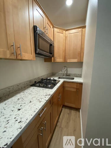 A kitchen with wooden cabinets and a granite countertop.