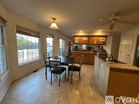 A kitchen with a table and chairs in the middle of the room.