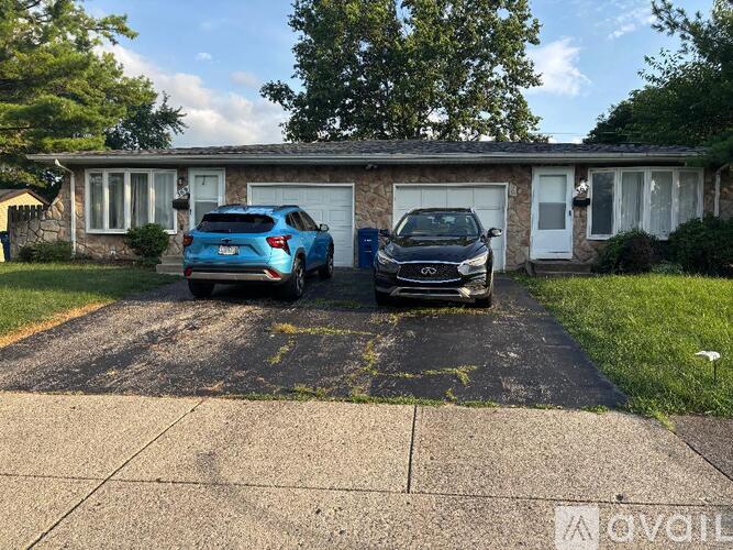A house with a car parked in front of it.