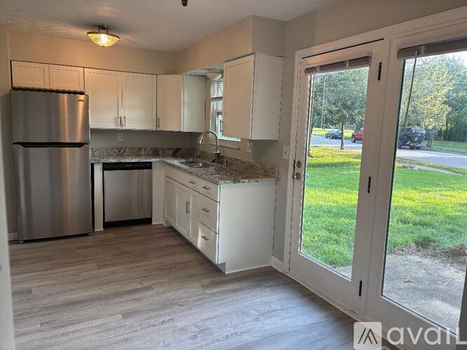 A room with a sliding glass door leading to a balcony.