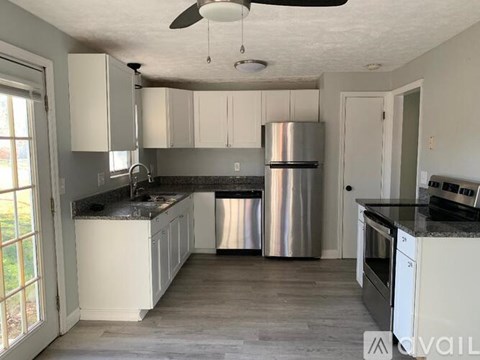A kitchen with a stainless steel refrigerator and oven.