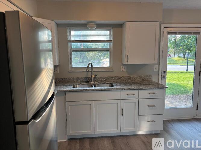 A kitchen with a granite countertop and a ceiling fan.