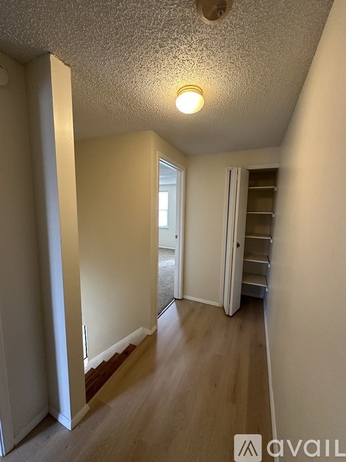 A room with a white ceiling and wooden flooring.