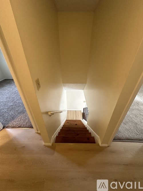A hallway with a staircase leading to the second floor.
