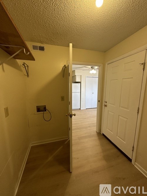 A hallway with a white door and a yellow wall.
