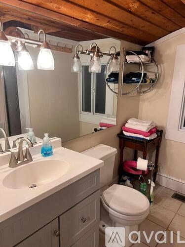 A bathroom with a white sink and a toilet.