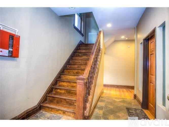 A staircase with wooden steps and a metal railing.