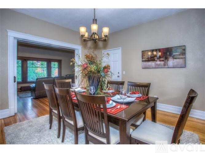 A dining room with a table set for six.