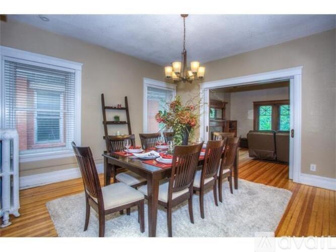 A dining room with a table set for six people.