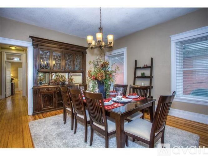 A dining room with a wooden table and chairs.
