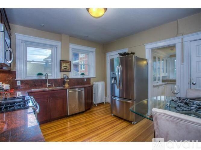 A kitchen with a refrigerator, stove, and sink.