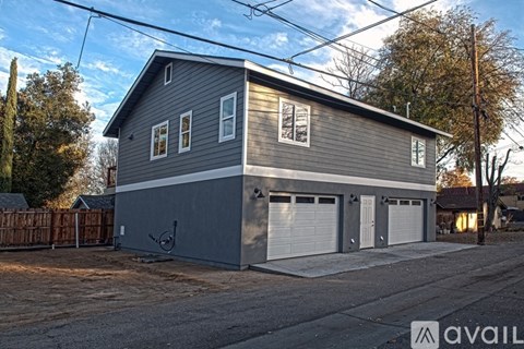 A two-story house with a garage is available for sale.