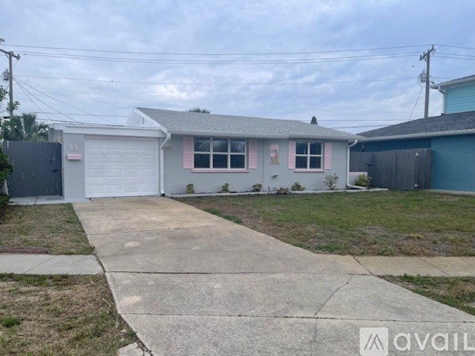 A house with a grey roof and a white garage door.