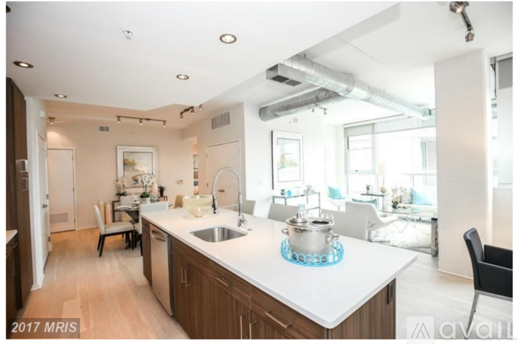 A kitchen with a white counter top and a sink.