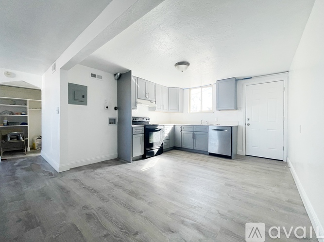 A spacious kitchen with a dining area and a living room.