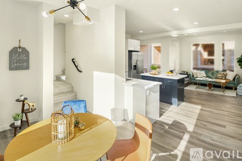 A modern living room with a dining table and chairs.