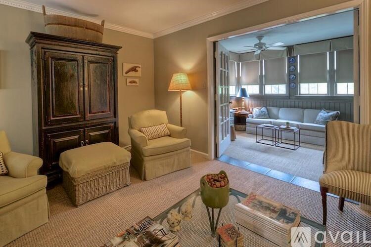 A living room with a large window and a view of a balcony.