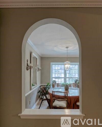 A dining room with a table set for six.