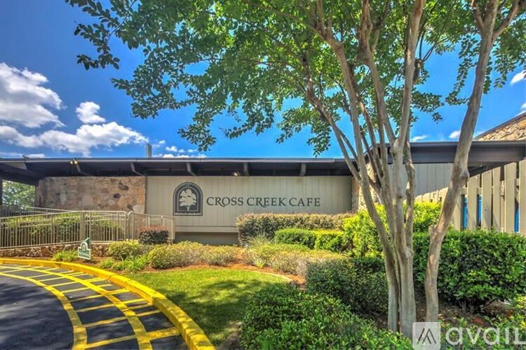 A building with a sign that says Cross Creek Cafe.