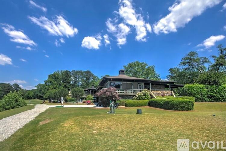 A house with a driveway and a lawn in front of it.