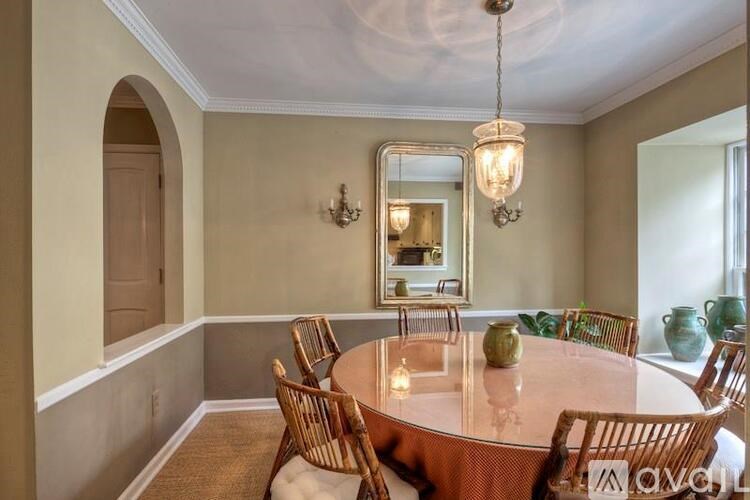 A dining room with a round table and chairs.