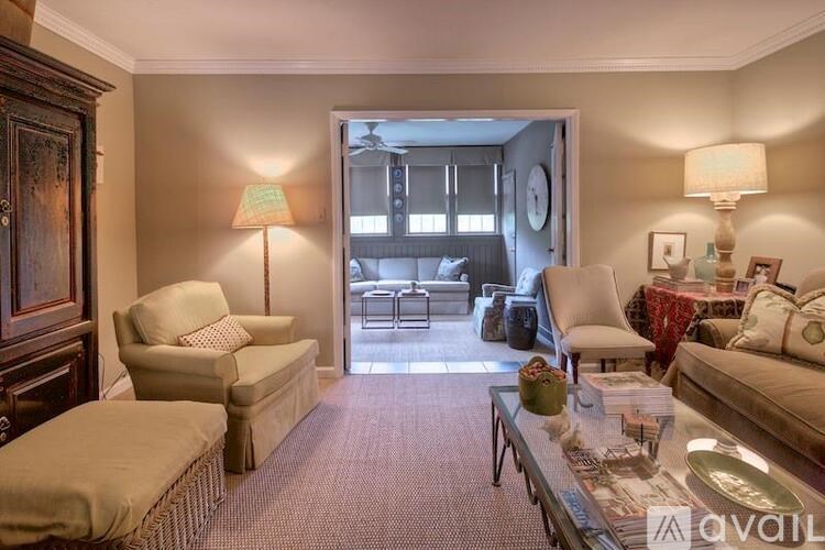 A living room with a sofa, armchair, and a coffee table.