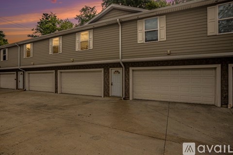 A row of houses with garages in front.