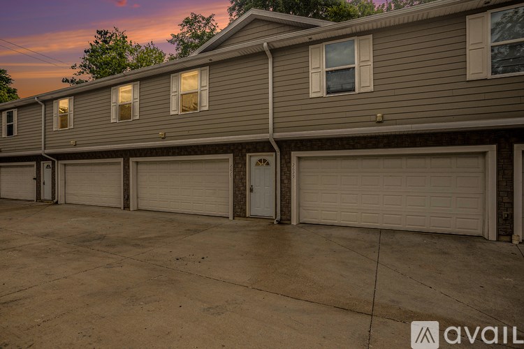 A row of houses with garages in front.