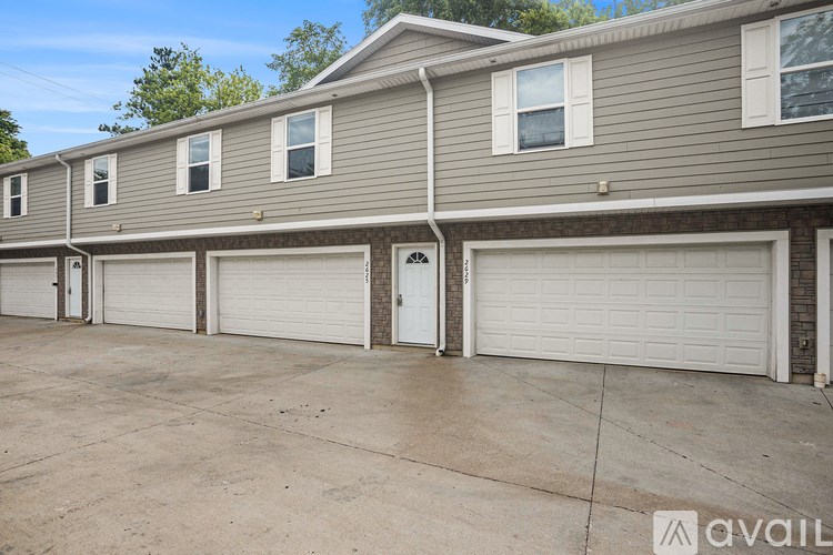 A row of houses with garages in front.