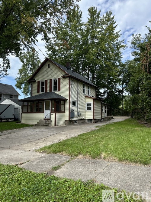 A house with a front porch and a driveway in front.