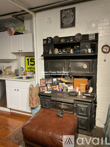 A cluttered room with a fireplace and a sign that says 15 MPH.