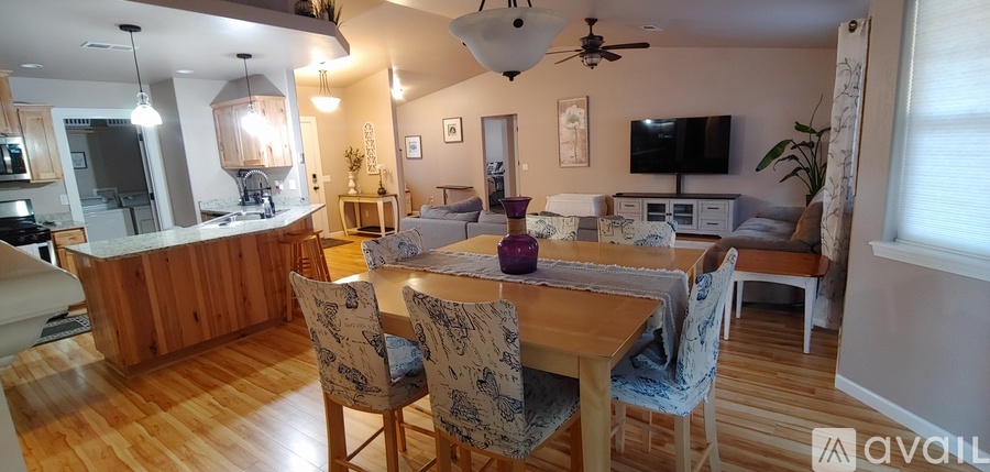 A dining room with a wooden table and chairs.