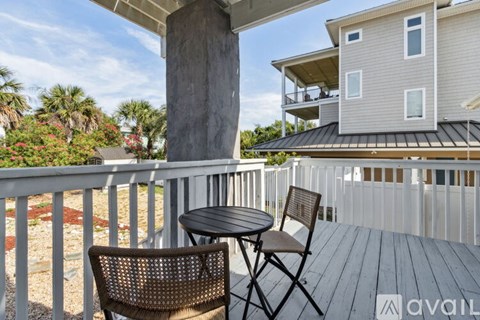 A balcony with a table and two chairs is available for rent.