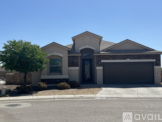 A house with a garage and a driveway in front.