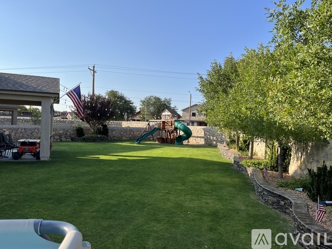 A backyard with a slide and a flag.