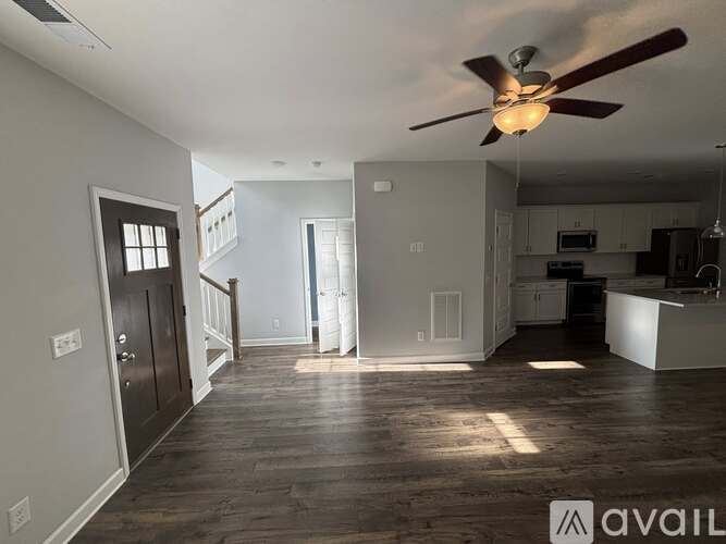 A living room with a grey couch and a wooden cabinet.