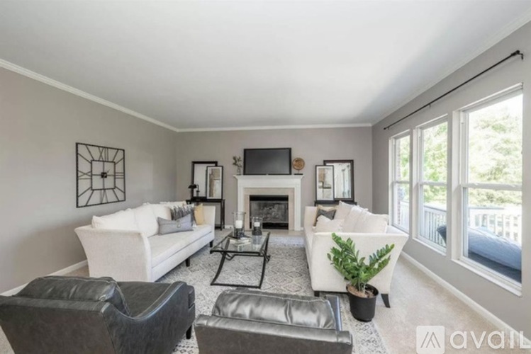 A living room with a fireplace and a television.