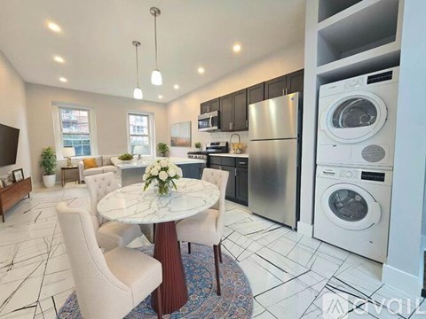 A modern kitchen with a dining table set up.