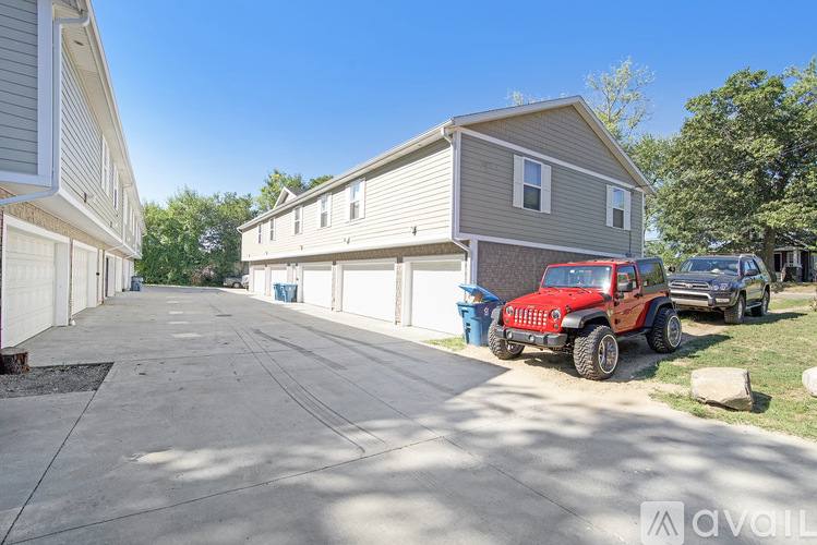 A red jeep is parked in front of a house.