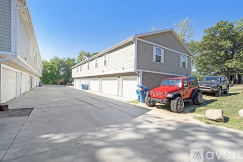 A red jeep is parked in front of a house.