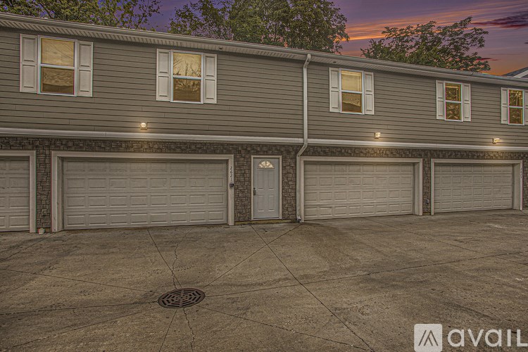 A building with a row of garage doors in front of it.