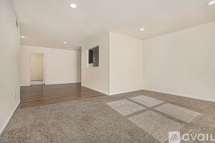 A room with a carpet and a wooden floor.