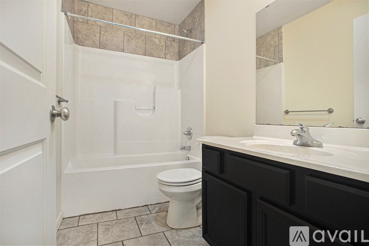 A bathroom with a toilet, sink, and shower.