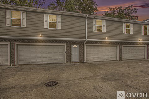 A building with a row of garage doors in front of it.