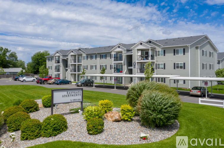 A large, multi-story apartment building with a sign that reads "Eaglevale Apartment.".