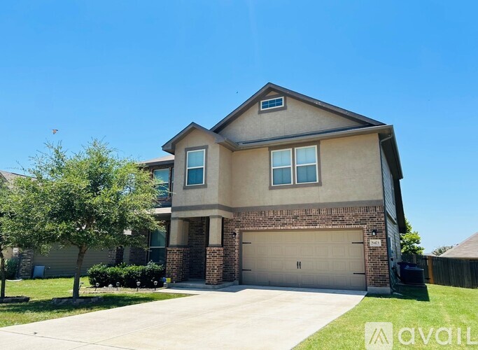 A two-story house with a garage is for sale.