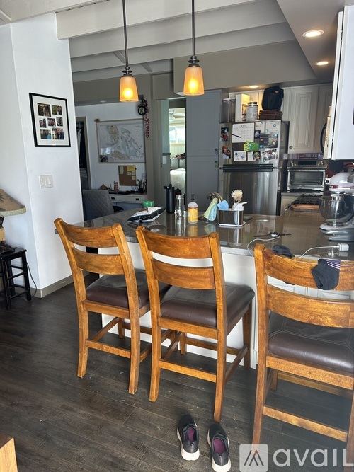 Two wooden chairs are in front of a kitchen island.