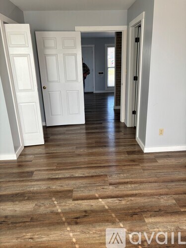 A hallway with a person standing at the end.