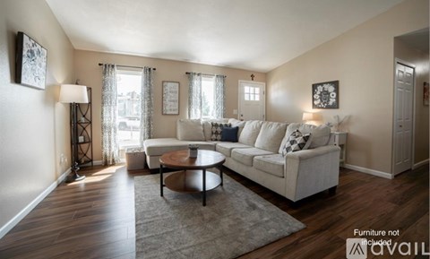 A living room with a white couch and a coffee table.