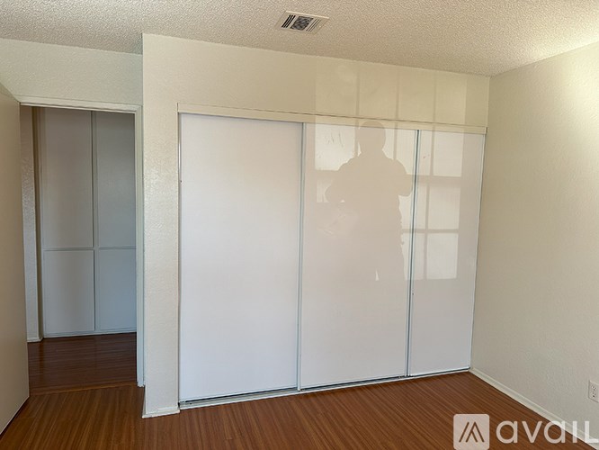 A room with a white wall and a white sliding door.